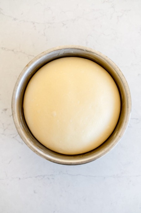 risen white bread dough in a bowl
