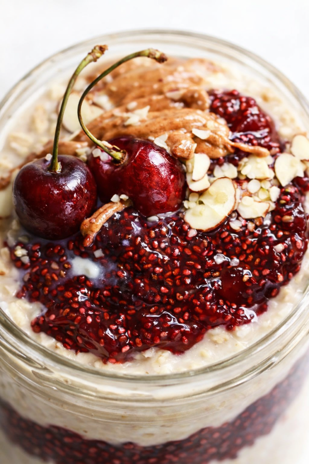 Final plated Healthy Overnight Oats with Cherry Chia Seed Jam served as a hero shot