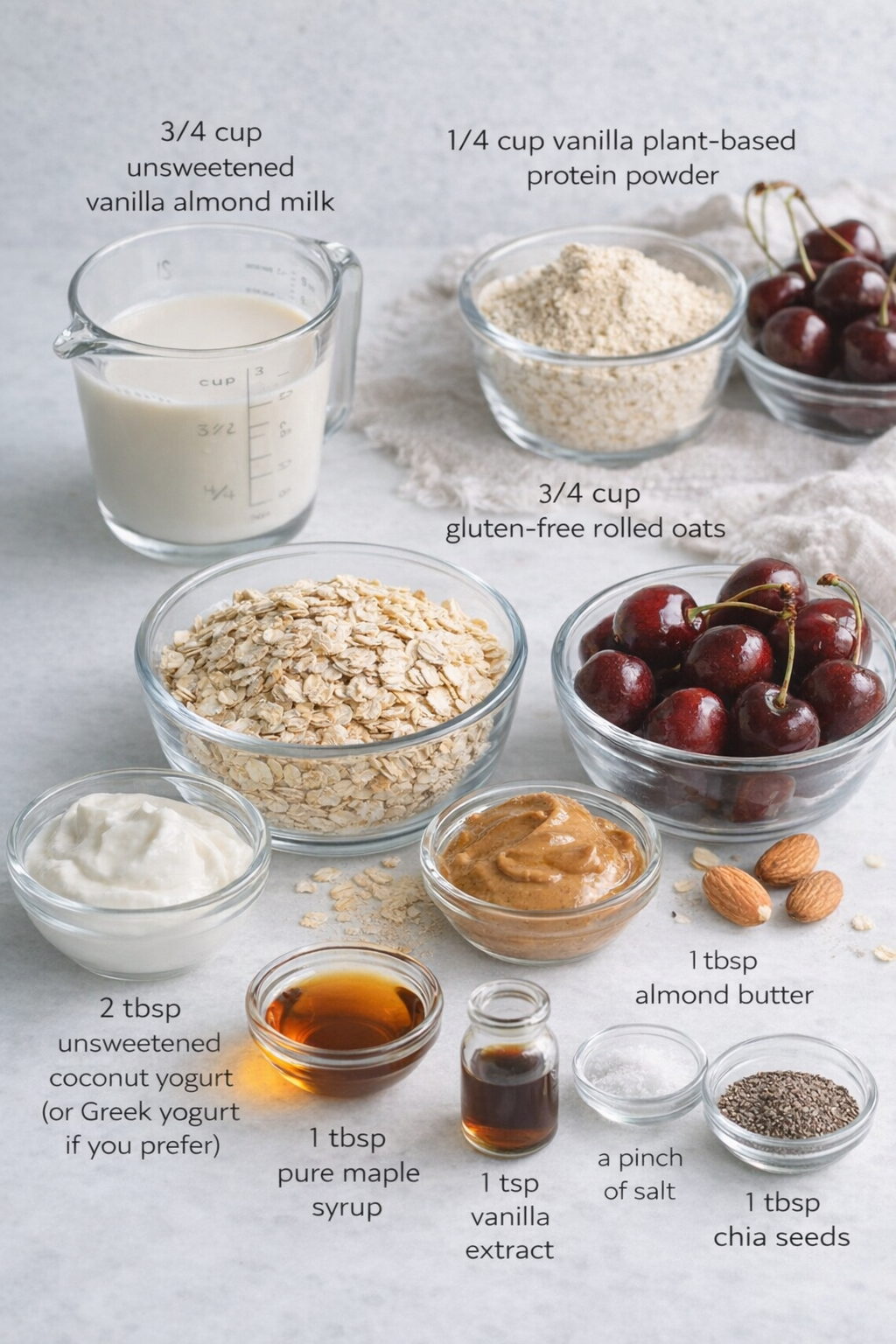 Measured ingredients arranged for Healthy Overnight Oats with Cherry Chia Seed Jam: 3/4 cup gluten-free rolled oats, 1/4 cup vanilla plant-based protein powder of your choice, 3/4 cup unsweetened vanilla almond milk, 2 t